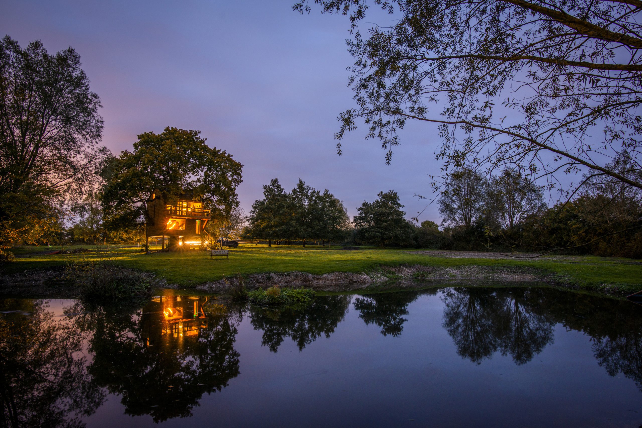 Nighttime photo of The Old Oak at Colemans Farm seen from the spring fed pond