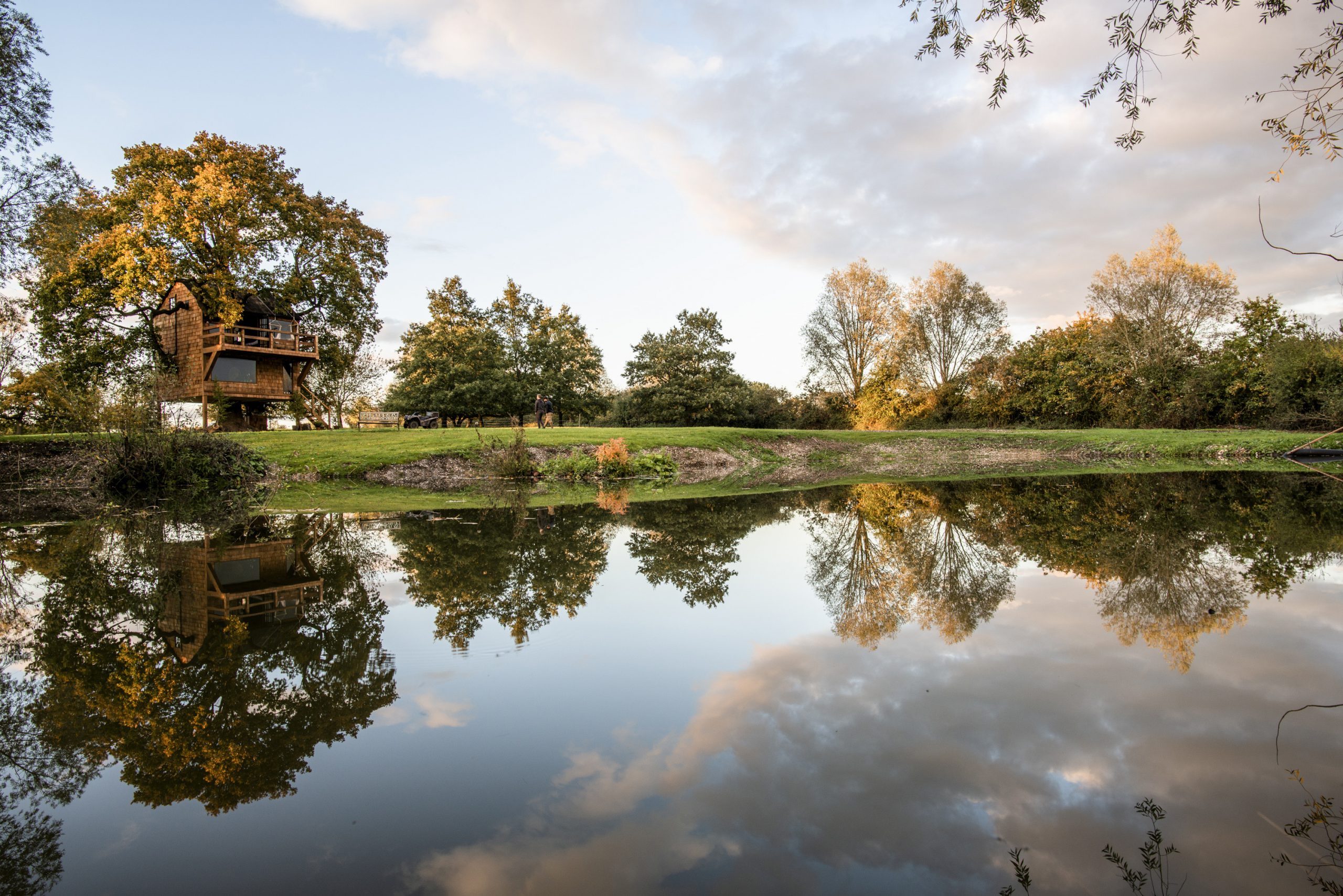 Daytime autumn photo of The Old Oak at Colemans Farm seen from the spring fed pond